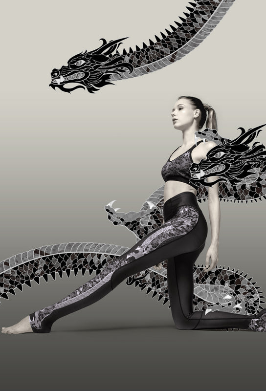 Women's elevated athleisure wear with tattoo-inspired dragon print on leggings and bra.